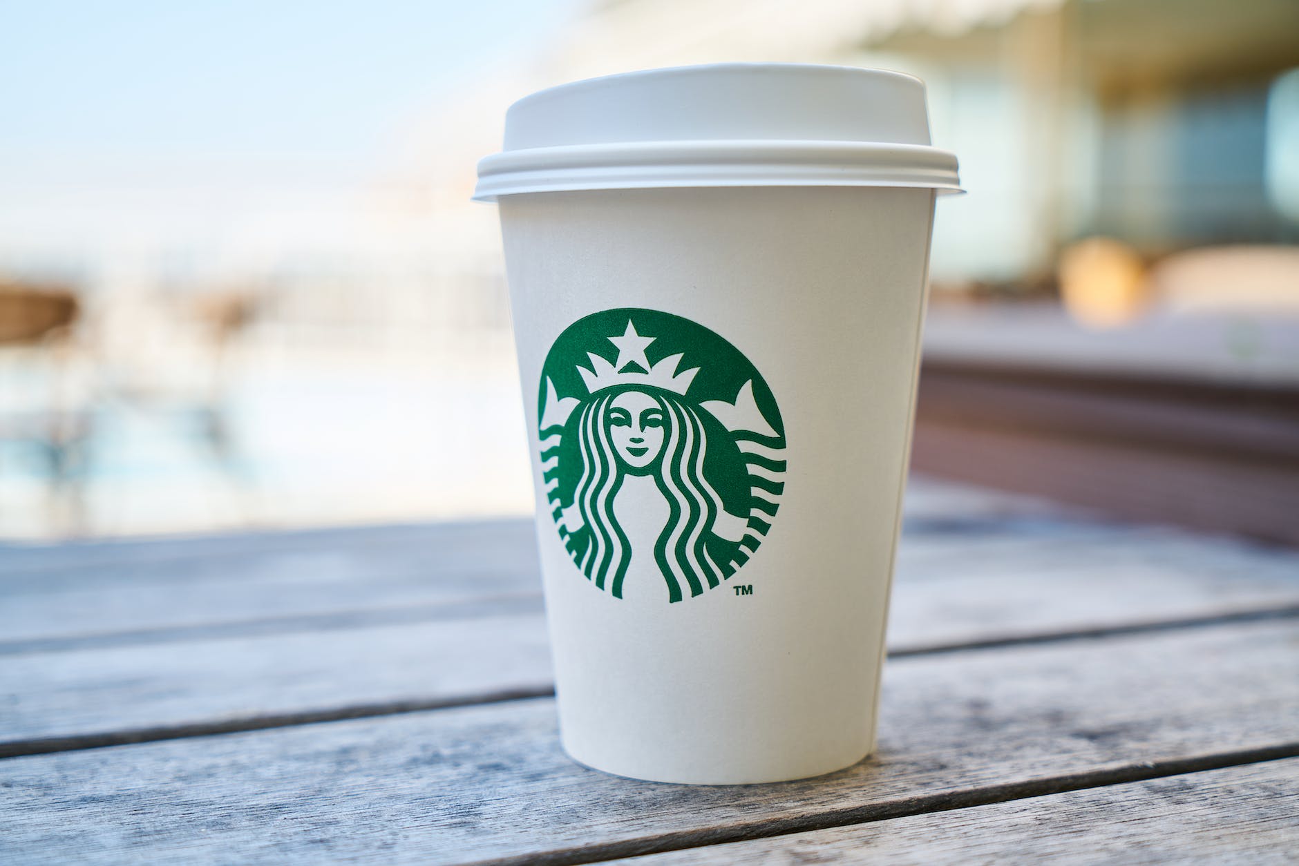 closed white and green starbucks disposable cup